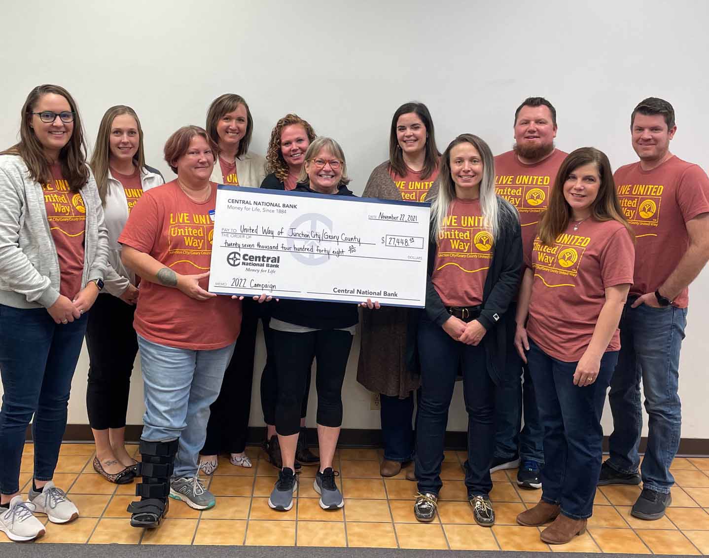 image of employees presenting check to the United Way committee